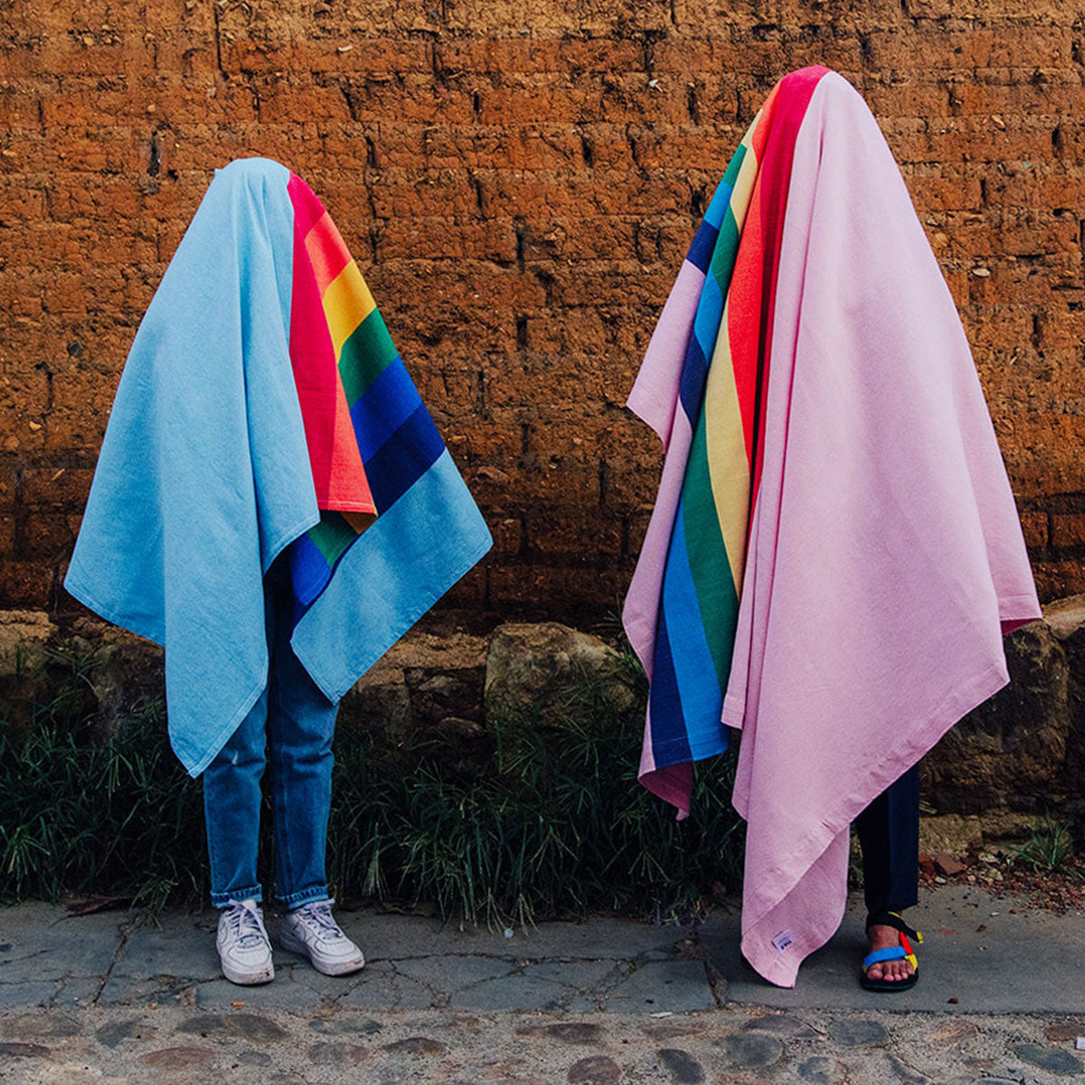 Proud gay couple wearing rainbow flag